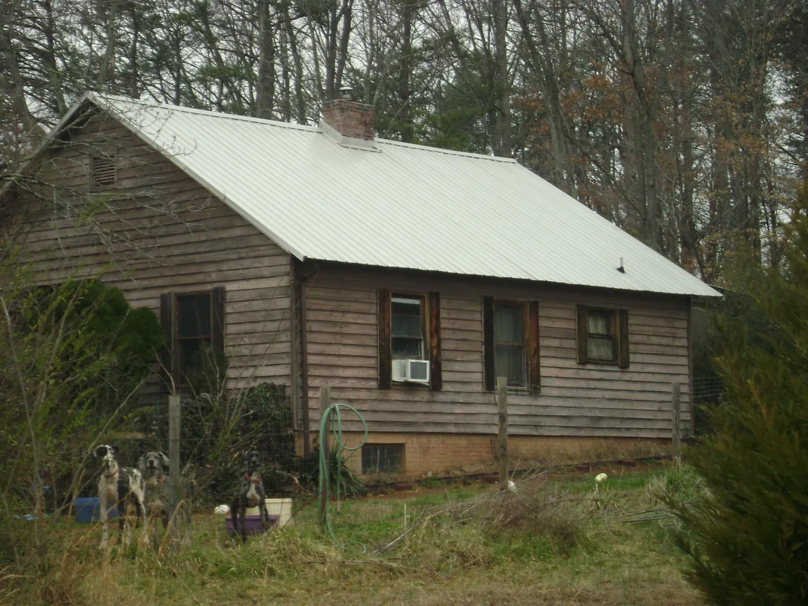 White metal roof on an old wood sided farmhouse, from a Metal Roof Installation job in Kaysville